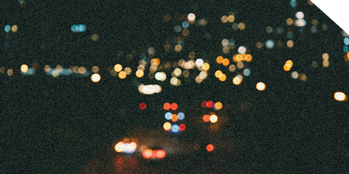 Of the World 2 Vague Headlights at night in a busy city
