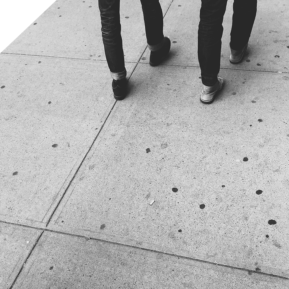 Walking With Photo of two pairs of feet walking side by side on a sidewalk.